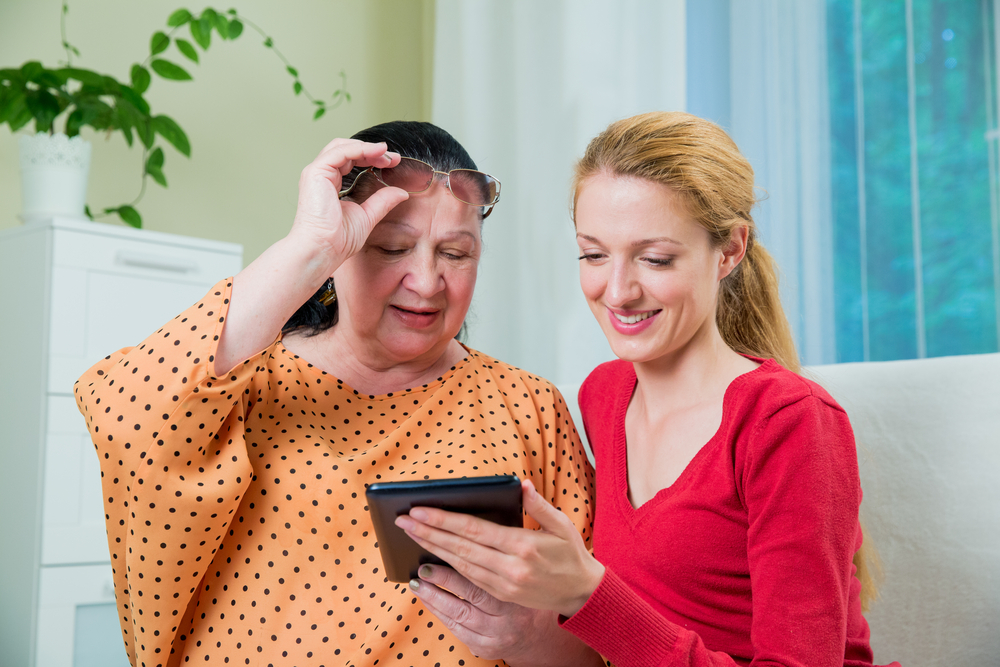 daughter teaching social media to mother